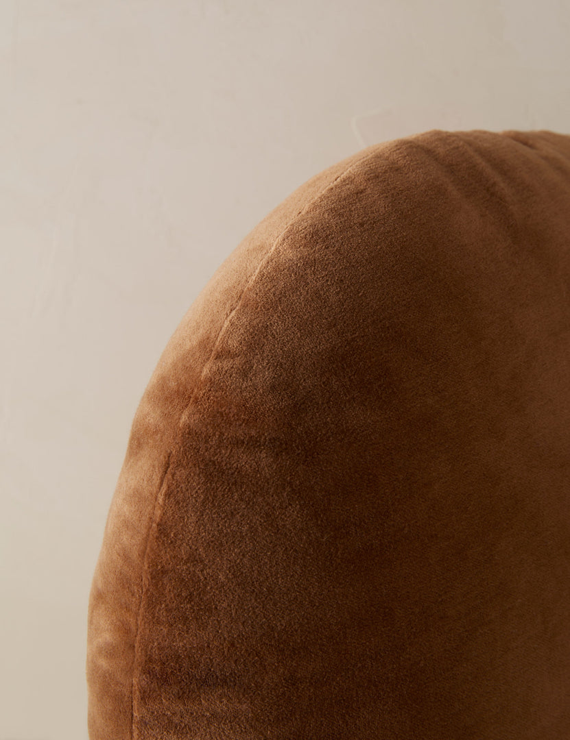 #color::umber | Close up view of the Velvet round accent pillow in rust umber