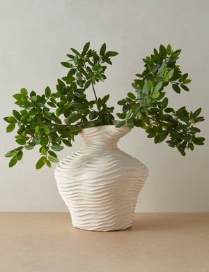 Wrinkle sculptural, textured glazed vase in ivory filled with greenery stems