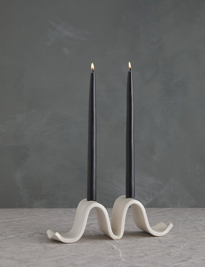 | Wyn white Candelabra by SIN with an undulating silhouette and two black taper candles