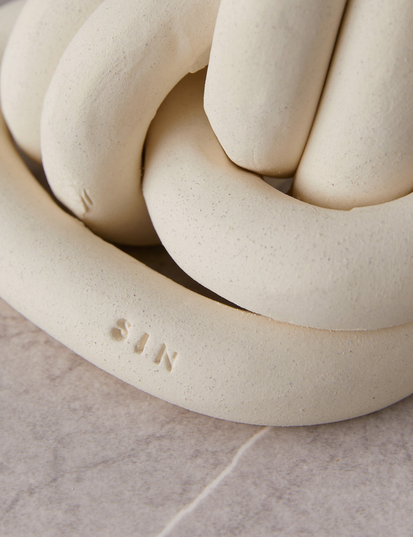 #color::white | Close up view of the decorative ceramic double coil XL Fist Knot by SIN Ceramics