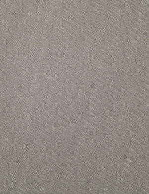 Detailed view of the lavastone material on the surface of the Agatha indoor and outdoor dining table with black iron base