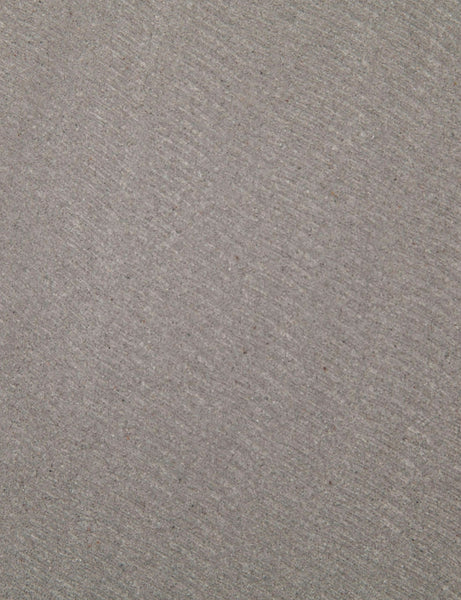 | Detailed view of the lavastone material on the surface of the Agatha indoor and outdoor dining table with black iron base