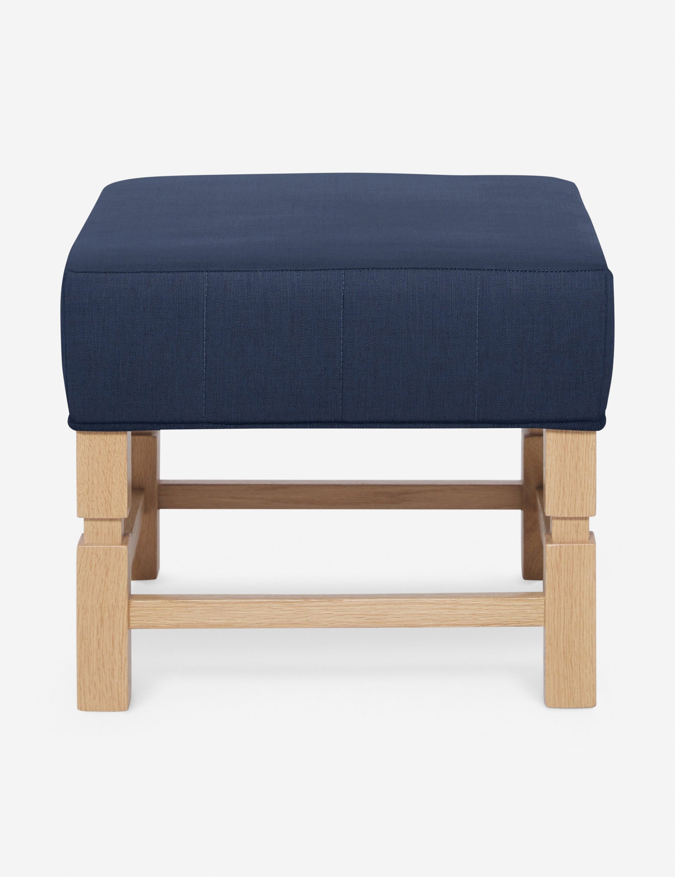 #color::dark-blue | Ambleside Dark Blue linen upholstered ottoman by Ginny Macdonald with a carved frame and vertical channeling on the cushion