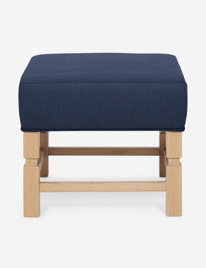 Ambleside Dark Blue linen upholstered ottoman by Ginny Macdonald with a carved frame and vertical channeling on the cushion
