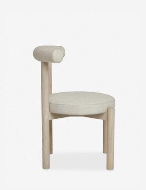 Side view of the Dame minimalist rounded open-back dining chair with ivory upholstered seat and ash wood frame