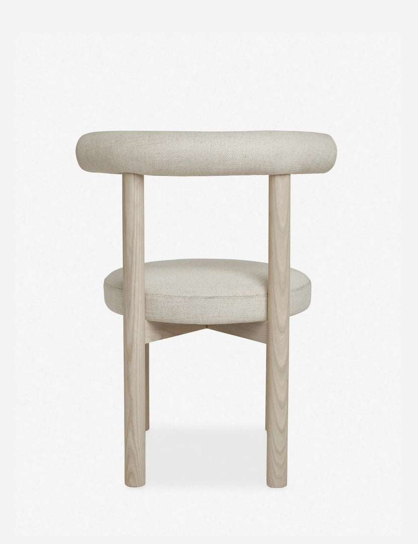 #color::whitewash | Rear view of the Dame minimalist rounded open-back dining chair with ivory upholstered seat and ash wood frame