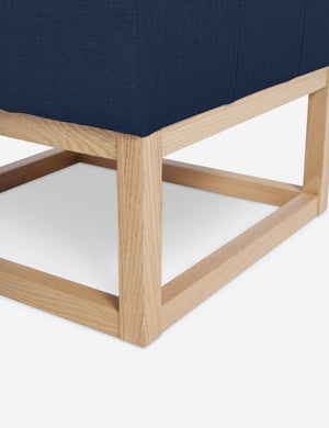 Close up of the airy wooden frame on the bottom of the Grasmere Dark Blue Linen Ottoman