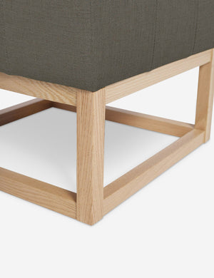 Close up of the airy wooden frame on the bottom of the Grasmere Loden Gray Linen Ottoman