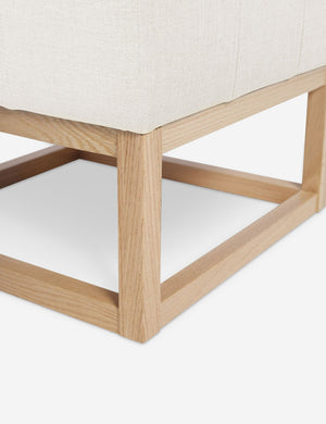 Close up of the airy wooden frame on the bottom of the Grasmere Oyster White Linen Ottoman