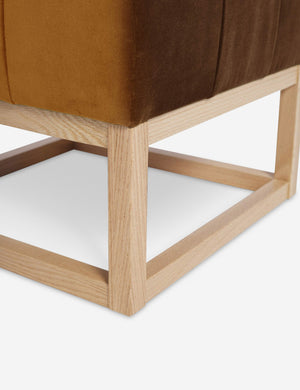 Close up of the airy wooden frame on the bottom of the Grasmere Cognac Velvet Ottoman