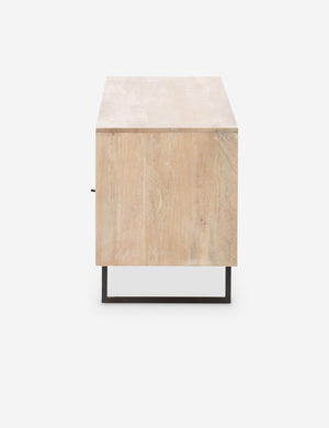 Side view of the Hannah natural mango wood media console with cane doors.