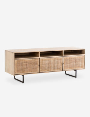 Angled view of the Hannah natural mango wood media console with cane doors.