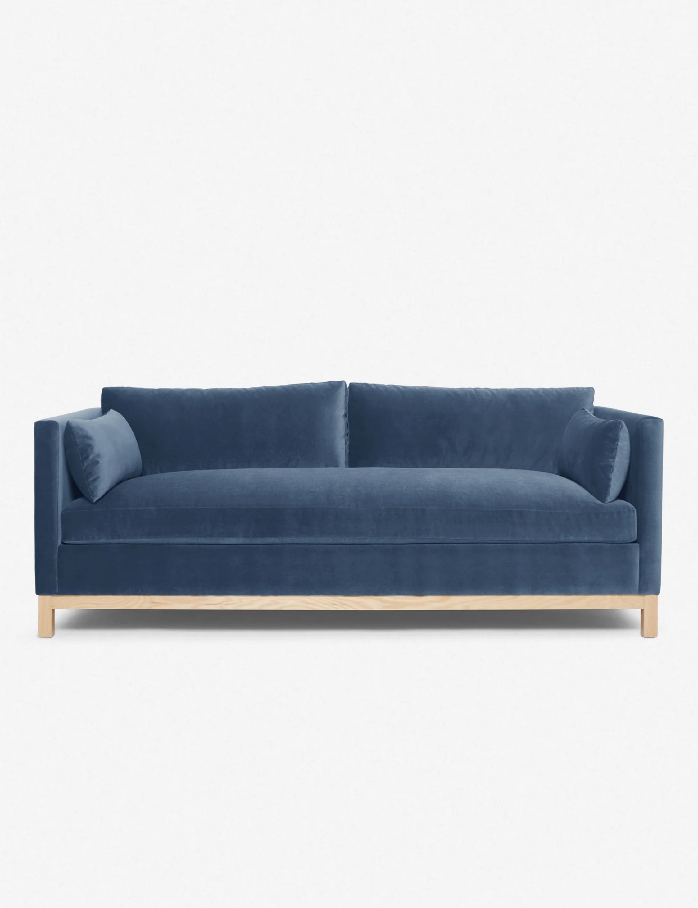 Back view of light-beige sofa showing fabric texture and natural wood base.