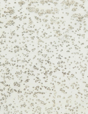 Detailed view of the texture of the mirror ash glass top on the Bridget bronze pedestal side table