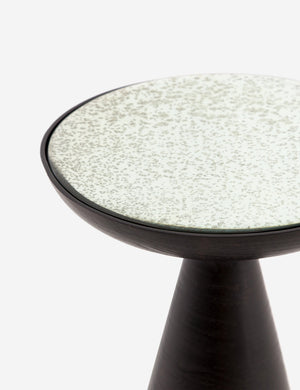 Close-up of the upper-half of the Bridget bronze pedestal side table with mirror ash glass top