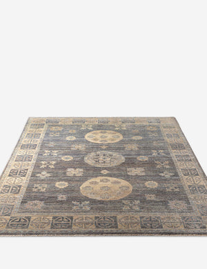 Angled view of the Aguirre traditional motif hand-knotted wool rug with subtle fringe