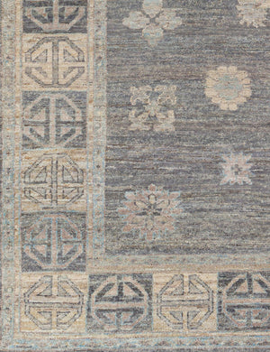 Close up view of the Aguirre traditional motif hand-knotted wool rug with subtle fringe