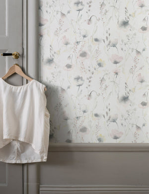 The Scalamandre Lo soft and pastoral gray toned floral wallpaper is in a room with greyish green accented walls