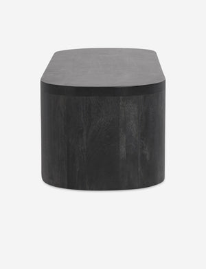Side view of the Luna black wood oval coffee table.