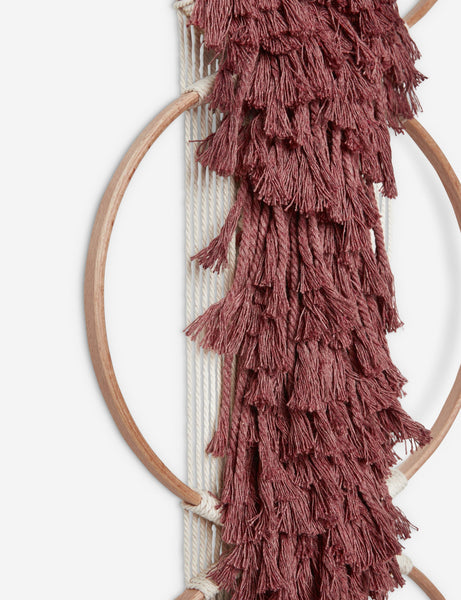 #color::brick | Close-up of the tasseled material on the Studio Nom Lwazi brick red woven Wall Hanging by nom