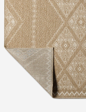Close up view of the back of the Mesny warm, neutral traditional print indoor/outdoor area rug
