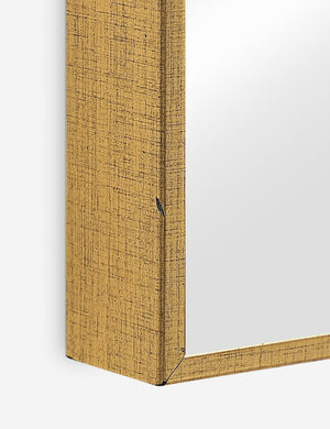 Close-up of the gold frame with slatted cutouts on the Shea rectangular full length floor mirror