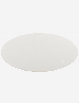 Bird's-eye view of the Thomas Bina oval coffee table with white laquered top, oak shelf and steel frame