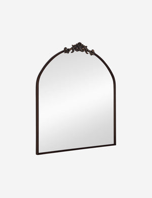 Angled view of the Tulca arched oil rubbed bronze mirror with flat bottom edge and traditional scroll detailing.