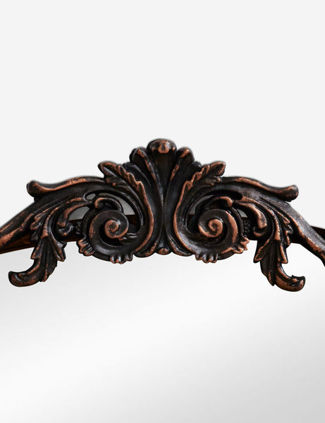 #color::oil-rubbed-bronze | Detailed view of the traditional scroll detailing on the top of the Tulca arched oil rubbed bronze mirror with flat bottom edge.