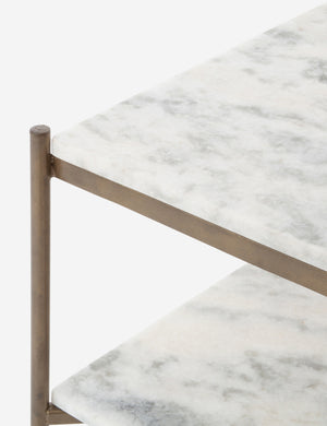 Close up of the Evander brass frame and white marble bar cart.