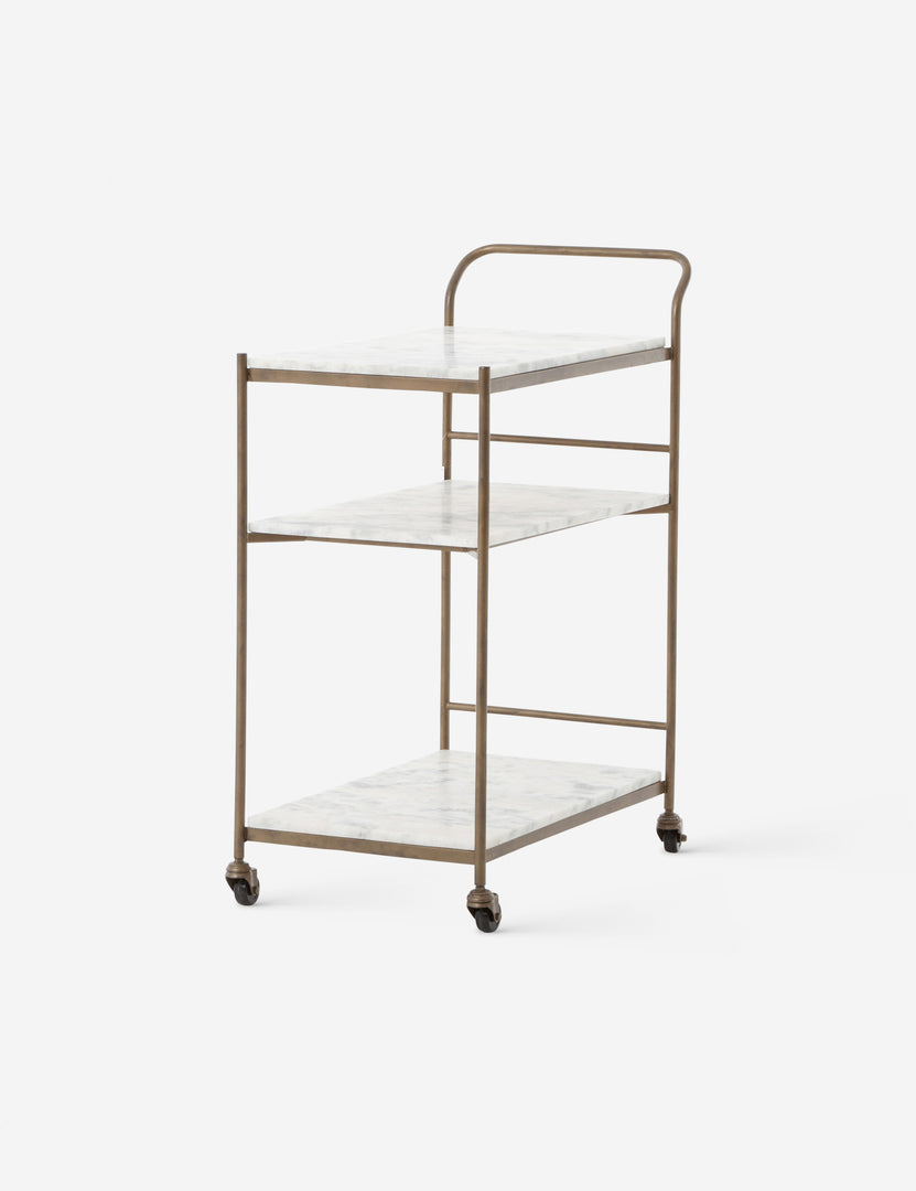 #color::antique-brass | Angled view of the Evander brass frame and white marble bar cart.