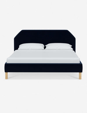 Kipp Navy Velvet upholstered platform bed with a geometric headboard and pinewood legs