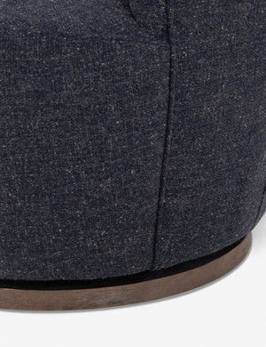 Close-up of the swivel base and fabric for the Margie rounded barrel swivel accent chair in slate