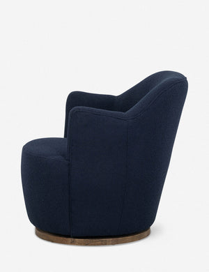 Side view of Margie rounded barrel swivel accent chair in navy