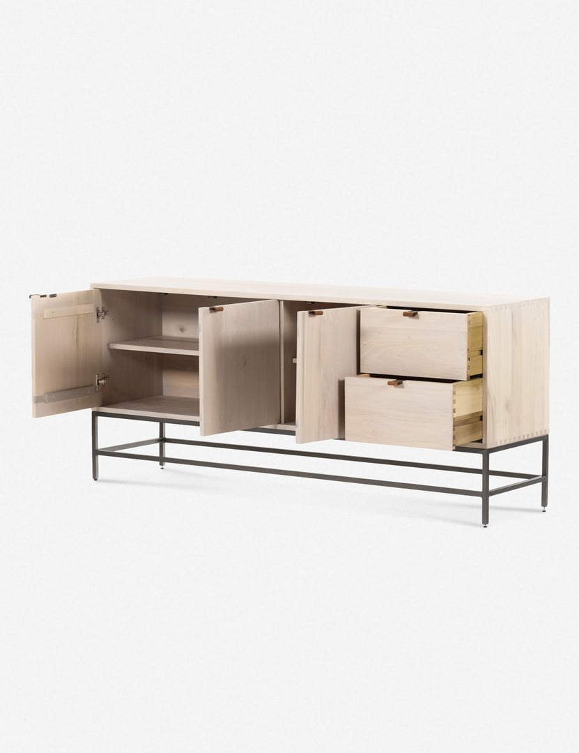 #color::natural | The three opened doors and two opened drawers of the Rosamonde natural wood sideboard with brown leather pulls and a metal base