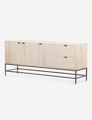 Angled right side view of the Rosamonde natural wood sideboard with brown leather pulls and a metal base