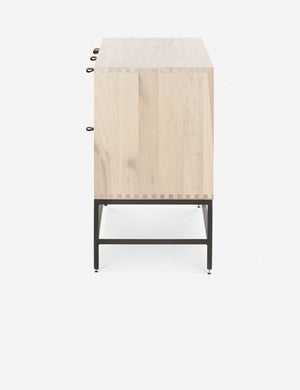 Side view of the Rosamonde natural wood sideboard with brown leather pulls and a metal base
