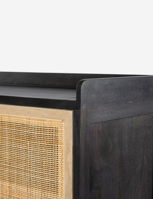 Close-up of the walled exterior surface of the Philene black mango wood sideboard with cane doors