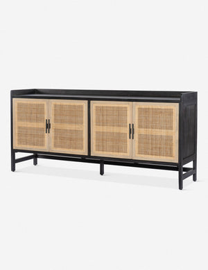 Angled view of the Philene black mango wood sideboard with cane doors