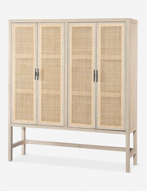 Angled view of the Hannah whitewashed mango wood cabinet with cane doors