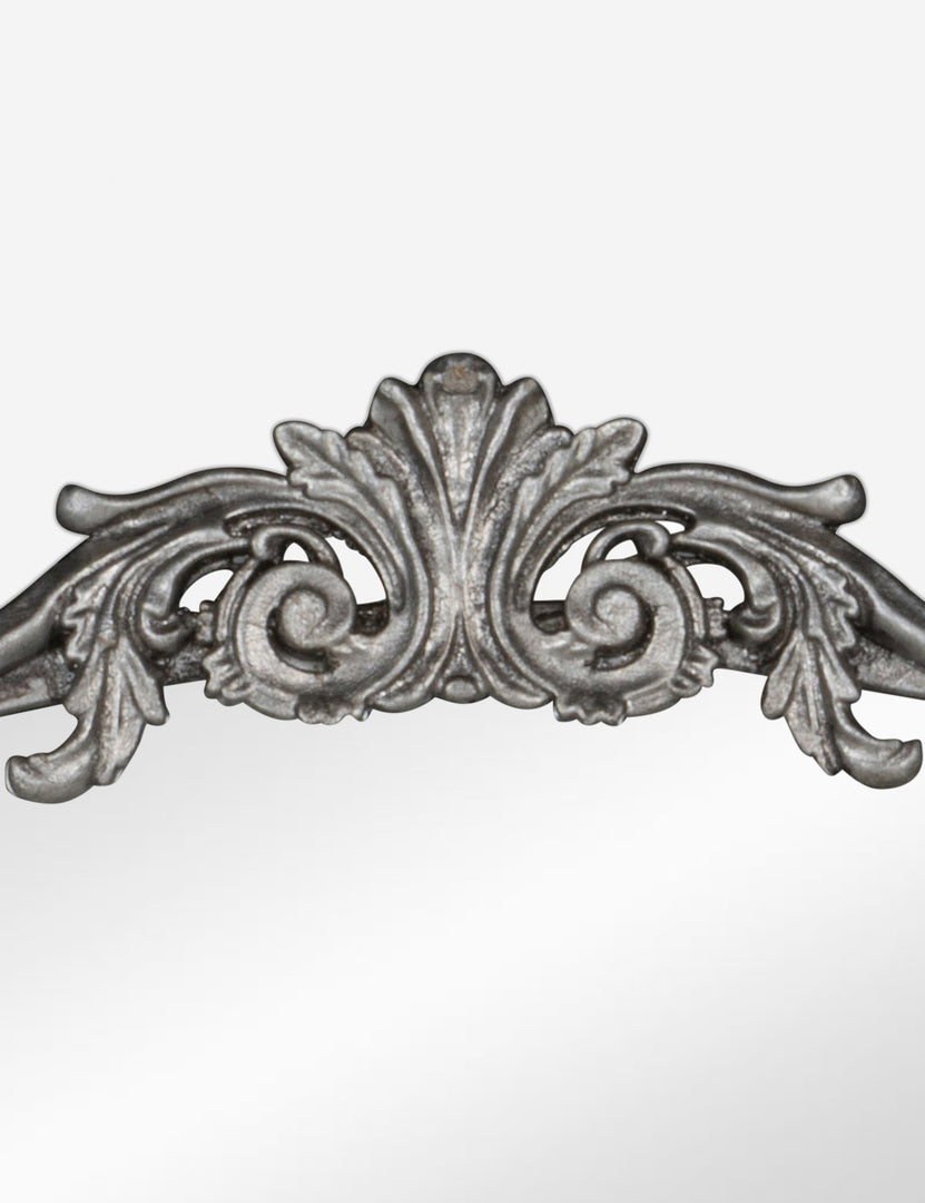 #color::silver | Detailed view of the traditional scroll detailing on the top of the Tulca silver curved standing mirror with flat bottom edge.