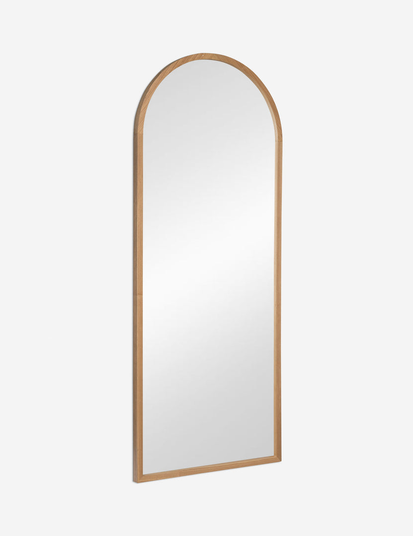 #color::natural | Angled view of the Paisley arched light wood framed floor mirror.