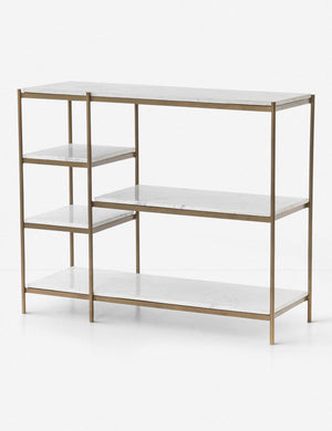 Angled view of the Kathleen console table with marble shelves and gold finish