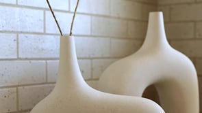 #color::white #size::small #size::large | Video of the Leonor sculptural arched matte white ceramic Vase in both its sizes