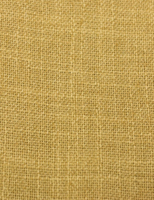 Close-up of the golden linen fabric on the Clementine platform bed