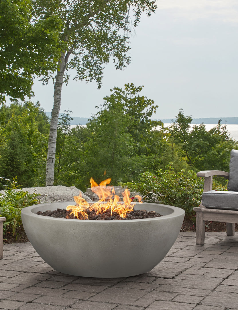 #color::shade #size::42- #configuration::propane | The Benno shade fire bowl sits in an outdoor space next to outdoor lounge furniture