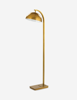 Angled view of the Otto natural brass arched floor lamp by Regina Andrew