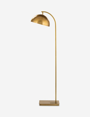 Angled view of the Otto natural brass arched floor lamp by Regina Andrew