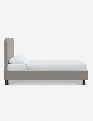 Side view of Clementine moonlight boucle platform bed with undulating lined headboard