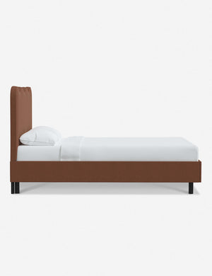 Side view of Clementine terracotta linen platform bed with undulating lined headboard